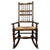 A charming early 20th century oak rocking chair, showcasing traditional craftsmanship and timeless country house appeal....