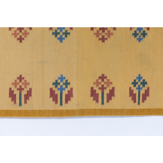 Swedish kilim runner in bright tone of yellow with flower motifs. Sweden circa 1960. All rugs undergo a professional...