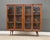 A mid century modern walnut bookcase with two glass doors. Made in the USA. Circa 1960’s. Original finish in very good...