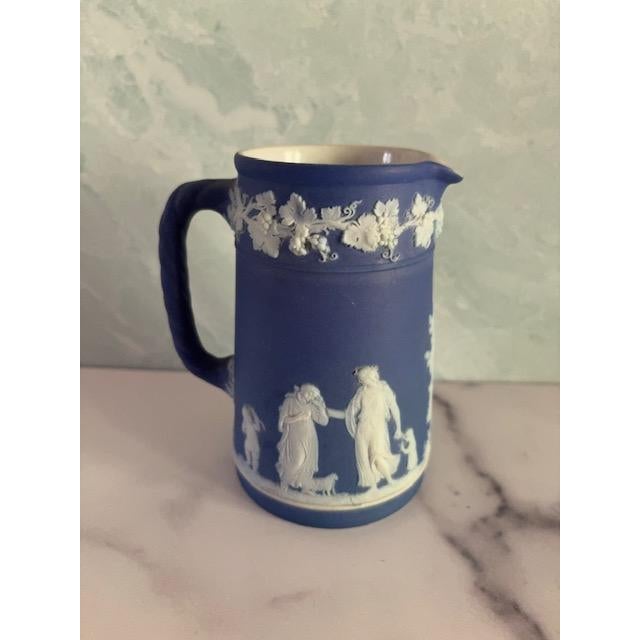 Lovely and graceful blue and white Jasperware pitcher from Wedgwood. Made in England. Decorated with familial figures,...
