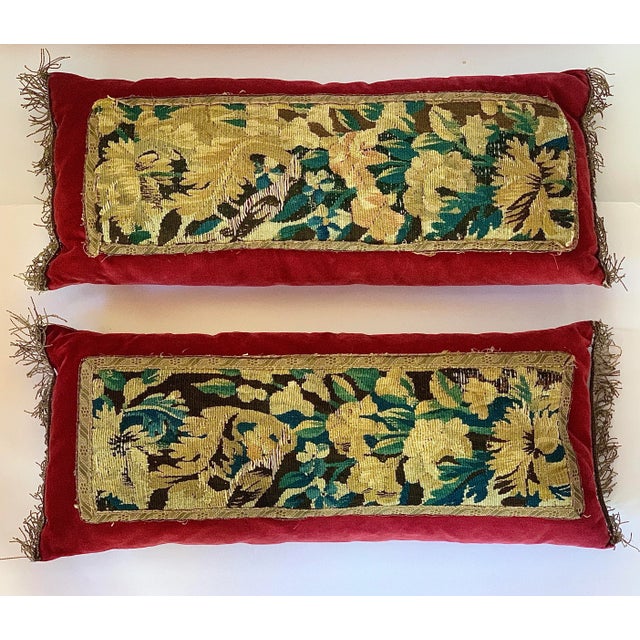 An exquisite pair of matching rectangular velvet lumbar pillows in a rich scarlet hue with an 18th century European, most...