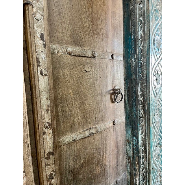 A striking antique architectural arch doorway crafted from solid teak, featuring hand-carved columns on either side and a...