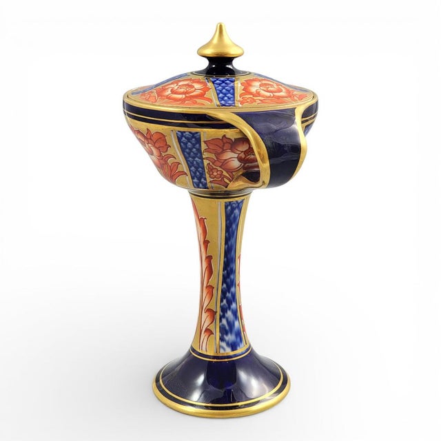 A decorative Aurelian Ware pedestal vase with cover and twin handles, model 143.9, designed by William Moorcroft for James...