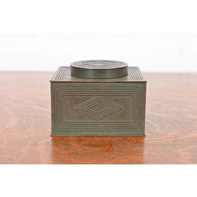 A gorgeous antique bronze inkwell featuring the iconic Graduate pattern in verdigris green patina By Tiffany Studios...