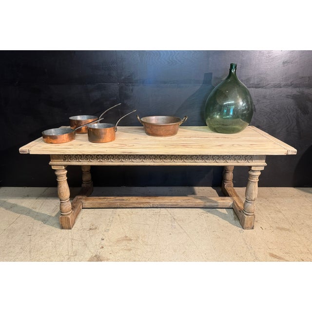 An English Oak Farmhouse Dining Table dating to the early 1900s. Having a carved freeze rail right round and sitting on 4...