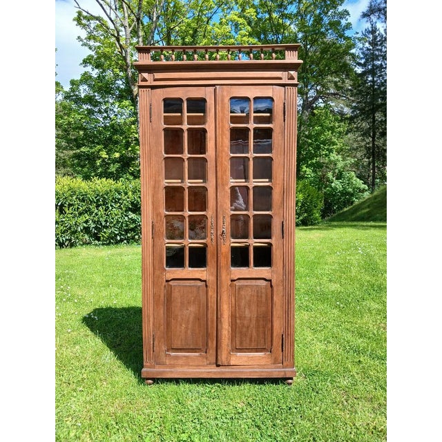 Bookcase with two glass doors, perfect for displaying your books or other objects. The sides are paneled. Three shelves....
