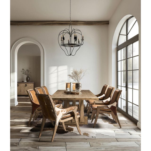 Dining table crafted from solid wood, this expansive rectangular table features a sculptural double pedestal design with...