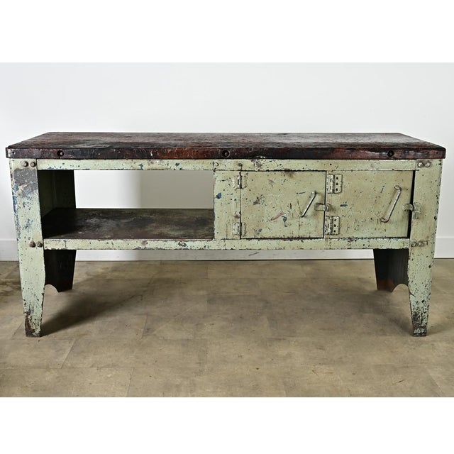 A fantastic industrial workbench from France, early to mid-20th century, assembled from a heavy steel case and a thick...