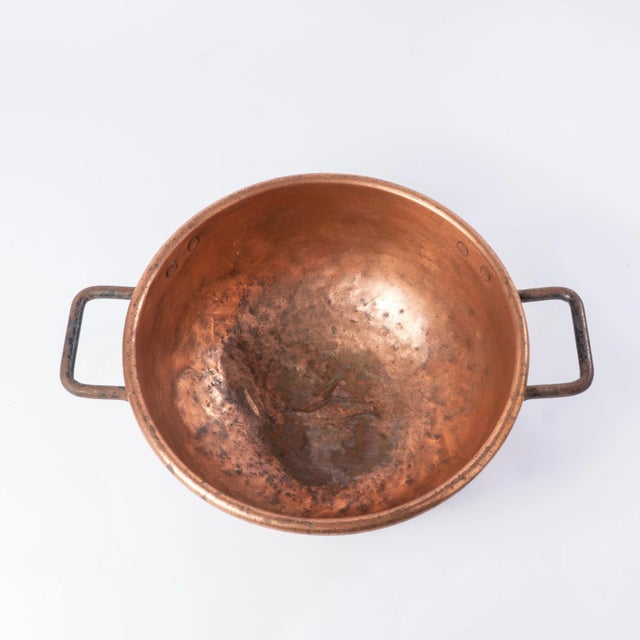 This antique 19th century copper pot would be a perfect decoration for any room. The oversized weathered copper pot has an...