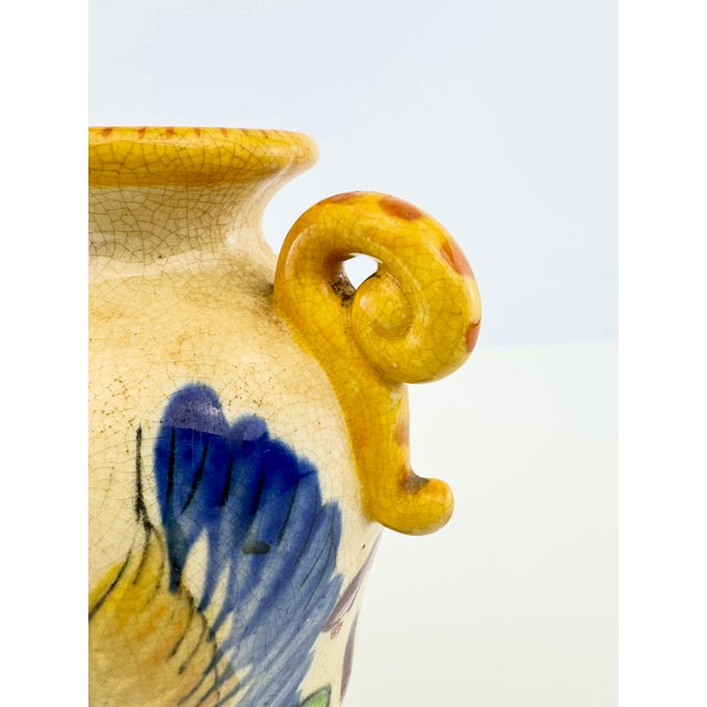 A striking antique Japanese pottery vase featuring a hand-painted golden dragon sweeping across a finely crackled cream...