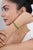 This statement tennis bracelet showcases 12.9 carats of natural round-cut emerald, set in 18k yellow gold. Each emerald is...