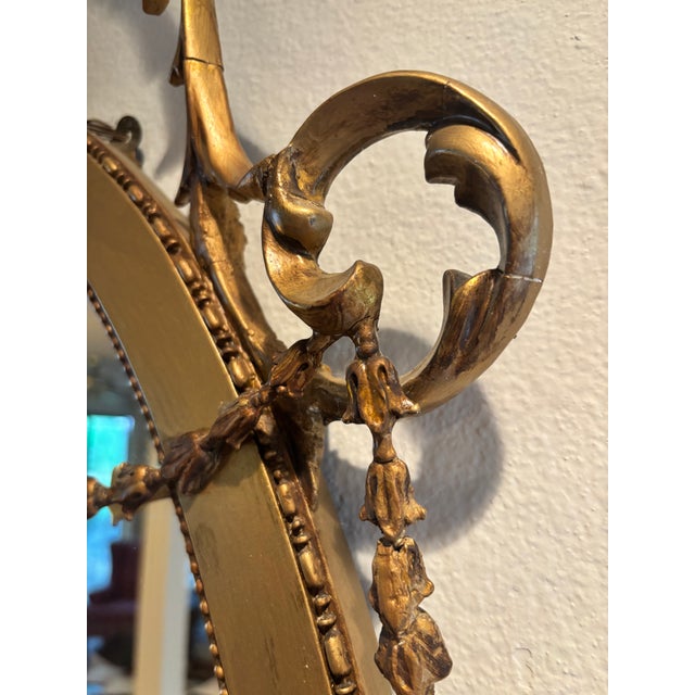 This elegant looking glass draws inspiration from 18th century British Neoclassical design popularized by architect and...