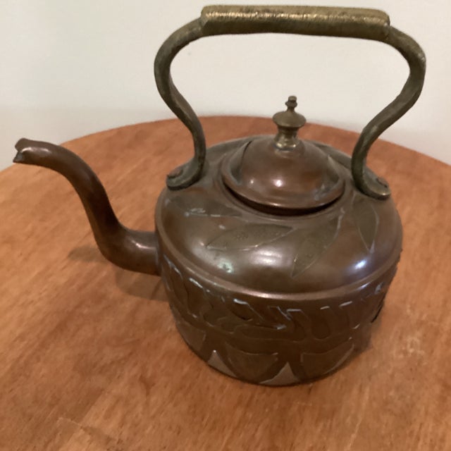 This large antique Victorian copper kettle is a unique piece with a beautiful brass and silver patchwork design on its...