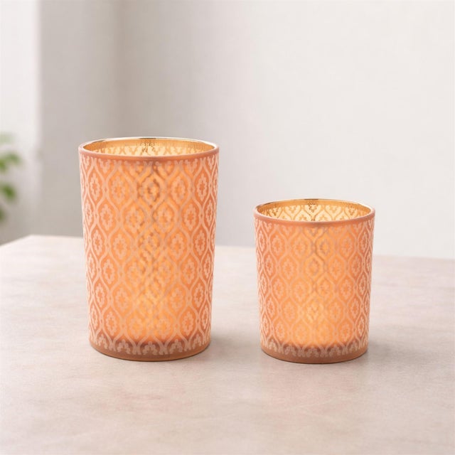 Bring warmth, sophistication, and artistry into your home with this set of patterned candle holders. Timeless geometry...