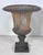 A pair of 19th century cast iron neoclassical urns, with traces of Gustavian blue paint within the exterior of their...