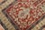 A geometric Caucasian shirvan rug from the early 20th century. Brick red field, earth accents in green and blue, circa...