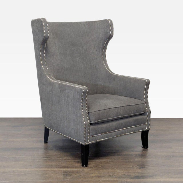 This Bernhardt lounge chair features a sleek gray fabric with a high back and winged sides for extra comfort. The chair is...