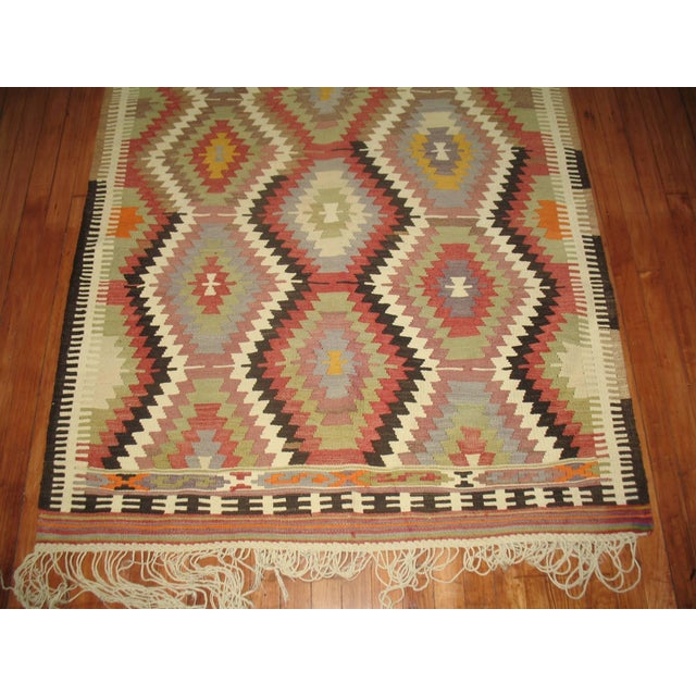 A vintage geometric Turkish Kilim scatter rug from the mid-20th century. Measures: 4'1'' x 6'3''.