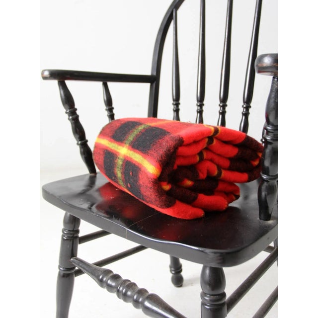 This is a vintage plaid woolen blanket. The classic throw blanket features a red, black, and yellow plaid. It is soft and...