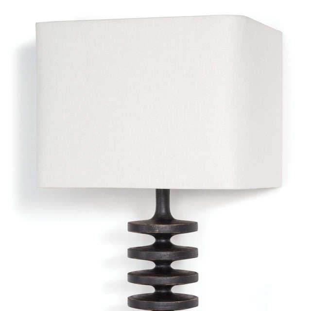 Textured bands ripple down the graduated column of our sculptural Fishbone sconce. Corrugated birch wood is handcrafted by...