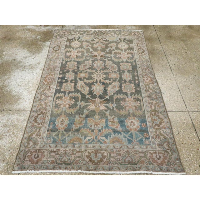 This mid-20th-century Persian Malayer accent rug presents a balanced floral and geometric composition across a muted blue-...