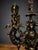 Discover the dark allure of this unique gothic-inspired candelabra, masterfully crafted in bronze to capture a distinct...
