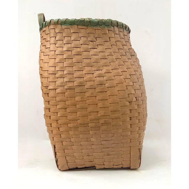Circa 1940s hand woven splint pack basket in original ochre and green paint found in Maine. Basket has a few breaks in...