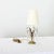 Dimensions: 16 ¼” H x 6” W x 6” D A darling, petite table lamp from late 19th century France rising from a brass...