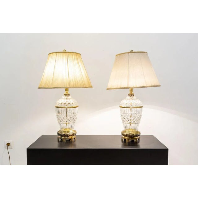 Pair of desk lamps with globular glass body carved and gilded bronze fittings. Pleated fabric lampshades with 45 cm in...
