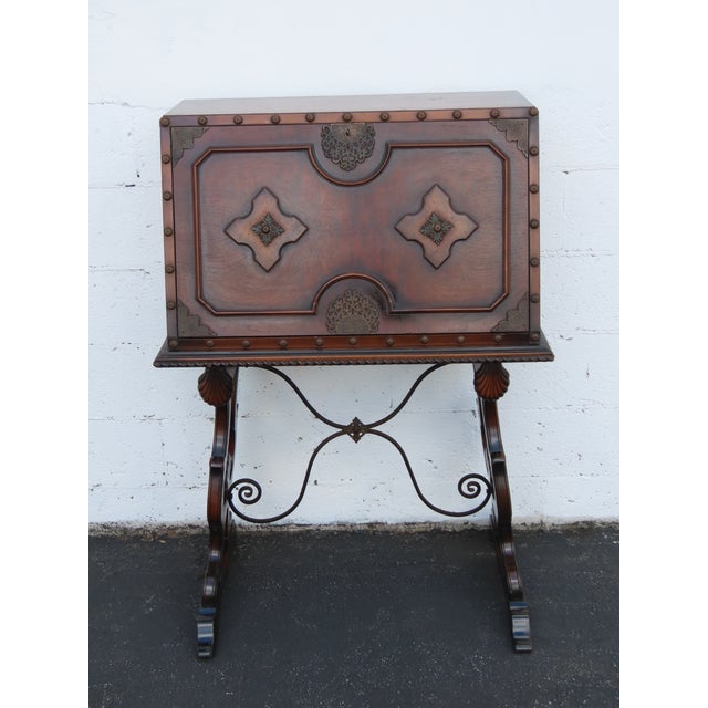 This Secretary Desk is made out of wood, solid wood, burlwood, veneer, and metal. This Secretary Desk has a Traditional...