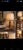 A turned wooden baluster-shaped floor lamp, patinated in warm brown tones. The stem features several rings and bands of...