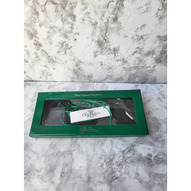 Set of four elegant and modern non-lead crystal ornaments. Each ornament is signed by Oleg Cassini. Brilliant sparkle and...