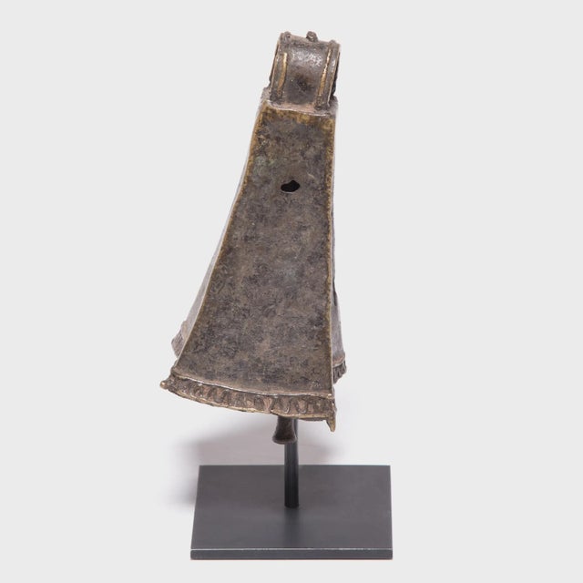 This four-sided brass face bell, known as omo, was created by an artisan of the Ijebu Yoruba people of Southern Nigeria. A...