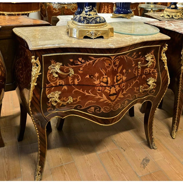 Make a statement with this magnificent French bombe commode, showcasing exceptional floral marquetry, graceful serpentine...