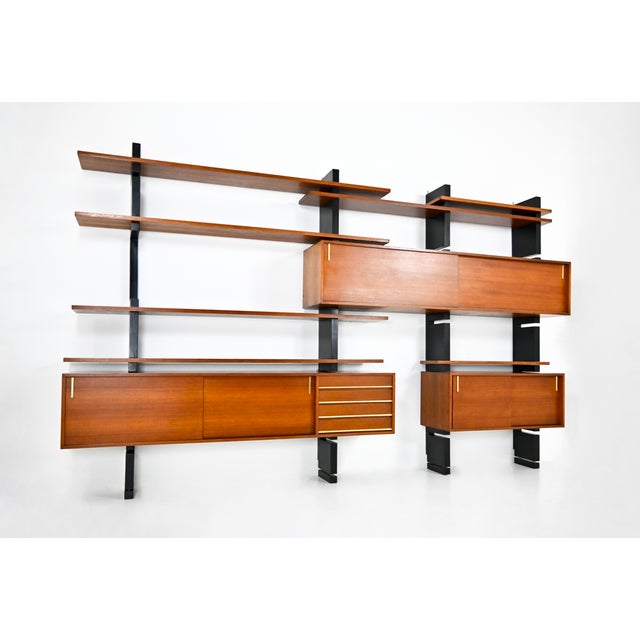 Large, fully modular wall unit consisting of 4 black uprights, 7 shelves, 1 small cabinet with 2 sliding doors, 1 large...