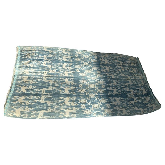 Antique indigo and white textile from Sumba. The perfect size to wear as a shawl. Mythical characters, horses and birds...