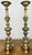 A beautiful pair of vintage brass candle holders featuring elegant turned columns, decorative floral detailing, and ornate...