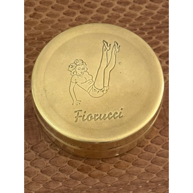 Vintage brass circular container by Fiorucci. Featuring an etched pin up girl on top. A rare piece from the 1980's.