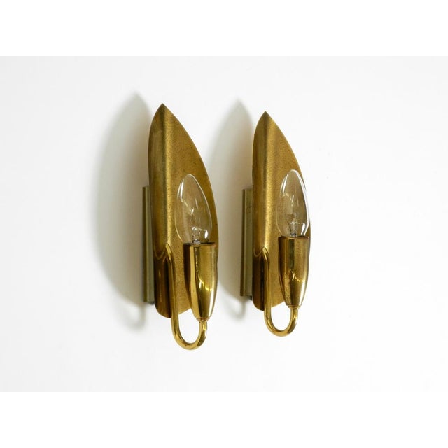 Two beautiful original Mid Century Modern brass wall lamps. Typical design of the golden 1950s. The lamps are made...