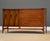 A mid century modern walnut three drawer dresser credenza with swooping walnut and brass arch details made by Broyhill...