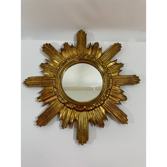 A gorgeous classic 16.75" Italian Giltwood Sunburst Wall Mirror from the 1960s. This hand crafted wood and gesso mirror...