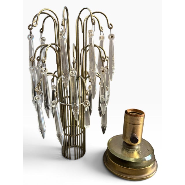 A spectacular vintage Hollywood Regency waterfall table lamp featuring an intricate brass-tone framework suspended with...
