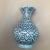 Floral mouth Persian mini vase vase signed by artist on the bottom.