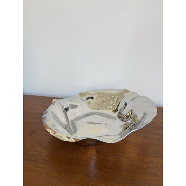 This sculptural Sarria bowl by Alessi is bound to become the centerpiece of the table! Designer: Lluis Clotet...