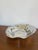 This sculptural Sarria bowl by Alessi is bound to become the centerpiece of the table! Designer: Lluis Clotet...