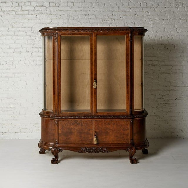 This 1930s Belgian buffet china cabinet showcases timeless European craftsmanship through its richly toned oak...