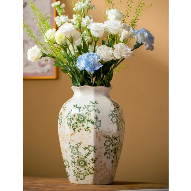 Elegant vintage Chinoiserie ceramic vase featuring a classic green and white color palette. The piece displays traditional...