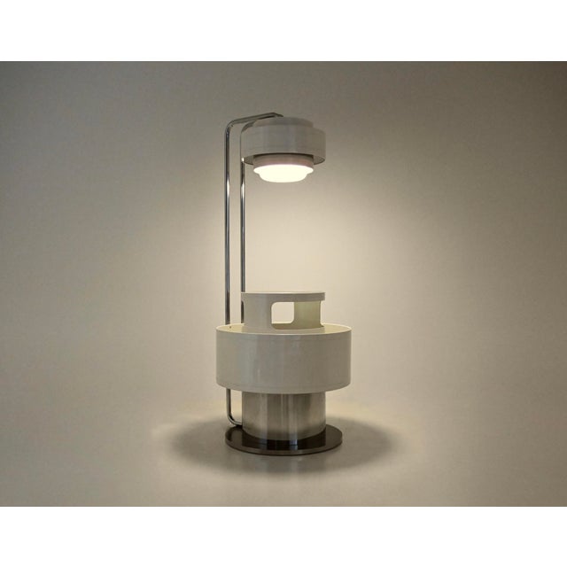 Italian bar set comprising a white bar unit made of plastic, metal, glass and wood, fitted with a lamp. ‍Signs of wear and...