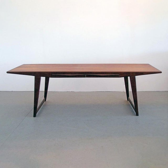 This beautiful rosewood coffee table, attributed to Johannes Andersen, has two sculptural drawers seamlessly integrated in...