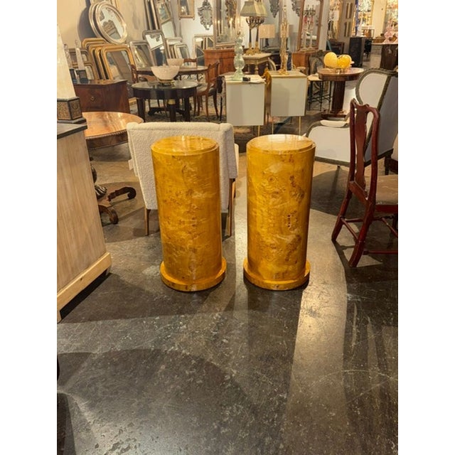 The product is a pair of Italian Art Deco design burl wood pedestals. These stylish pedestals showcase intricate artistic...